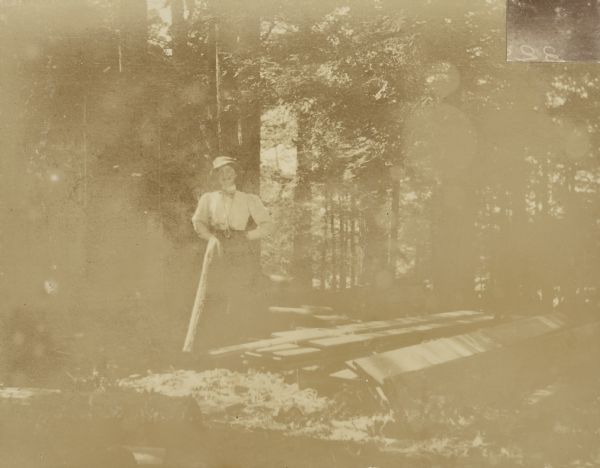 Mary Matilda Rumsey visiting "The Hermit" island, where George H. Holt had a summer cottage on Archibald Lake. Caption reads: "A 'Friend.'"