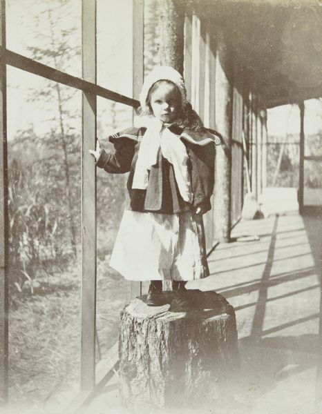 Jeannette Holt giving a stump speech on the porch at Island Lodge on Archibald Lake. Caption reads: "A stump speech by Jeannette."