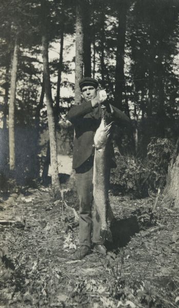 Rev. John Robertson Macartney is holding a freshly caught pickeral on a stringer. Maiden Lake is in the background. Page heading reads: "Rev. J. Robertson Macartney, Pickeral, Maiden Lake 1903."
