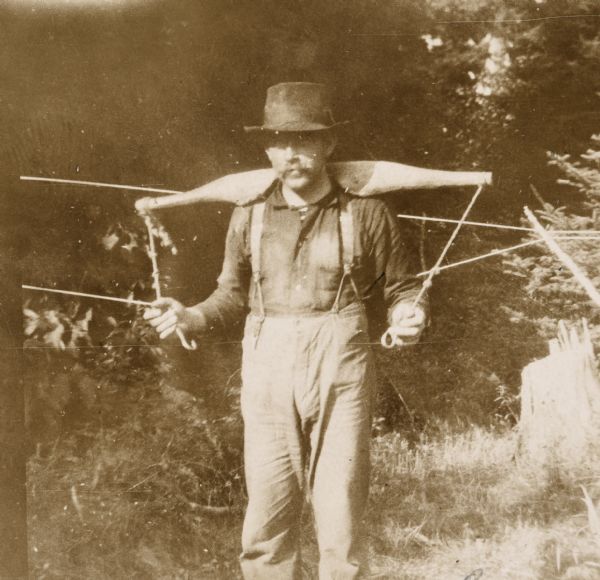 Portrait of Gus, who is wearing a water yoke on his shoulders. Caption reads: "Gus."