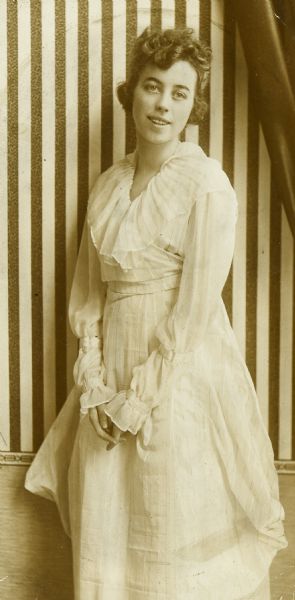 Portrait of Ethel Cecil Duecker, a good friend of Jeannette Holt. Striped wallpaper is in the background.