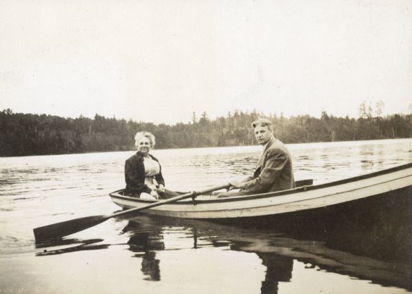 Mr. and Mrs. Buswell are in a rowboat on Archibald Lake. Caption reads: "Mr. and Mrs. Buswell."
