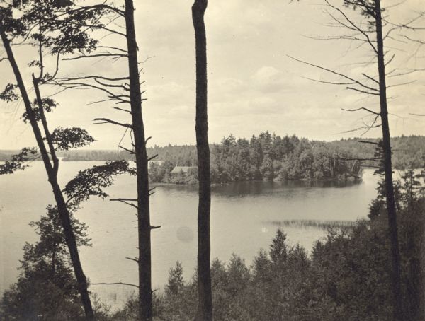 View from hill looking across the eastern half of Archibald Lake. In the distance is the narrow passageway connecting the east and west sides of the lake. In the center is the southeast side of the wooded Island, including the Ark cottage.