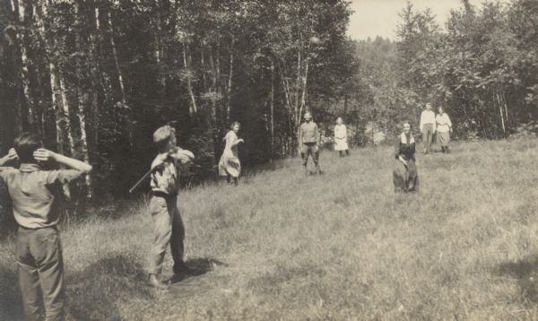 View of a baseball game on the Island. Juliet Rumsey Stroh (?) is pitching. W.A. Holt is standing by second base. Alfred Holt is standing near third base.