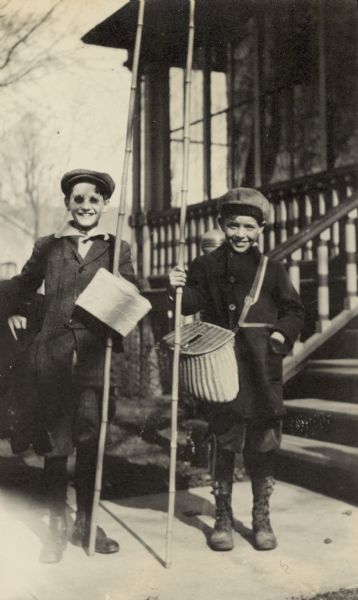 Donald Holt (left) and Fred Mooney (right) are posing with their fishing gear.
