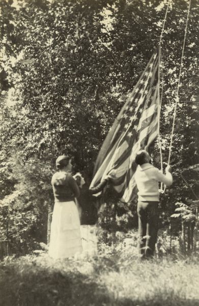 It is time to raise or lower the American Flag by members of the Holt family during their stay on the Island at Archibald Lake.