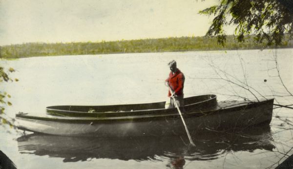 Mr. Bell is standing in a boat, holding a long pole. Caption reads: "Mr. Bell."