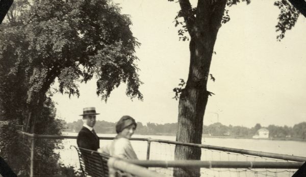 W.A. Holt and daughter Jeannette Holt are sitting on a bench with Lake Geneva in the background. Caption reads: "Lake Geneva."