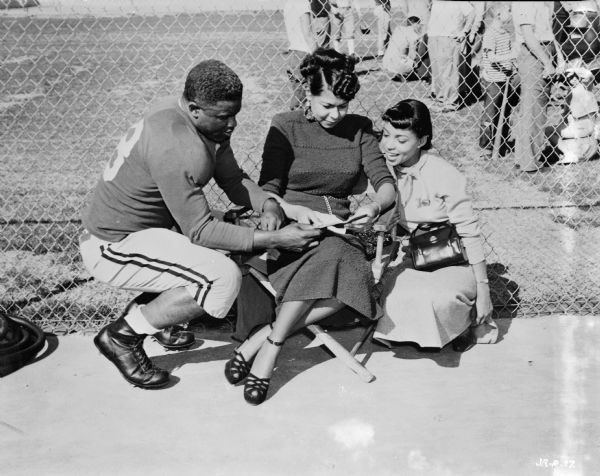Jackie Robinson, Rachel Robinson and Ruby Dee during the production of the 1950 film "The Jackie Robinson Story." Robinson and Dee are in costume, with the former wearing a football uniform.