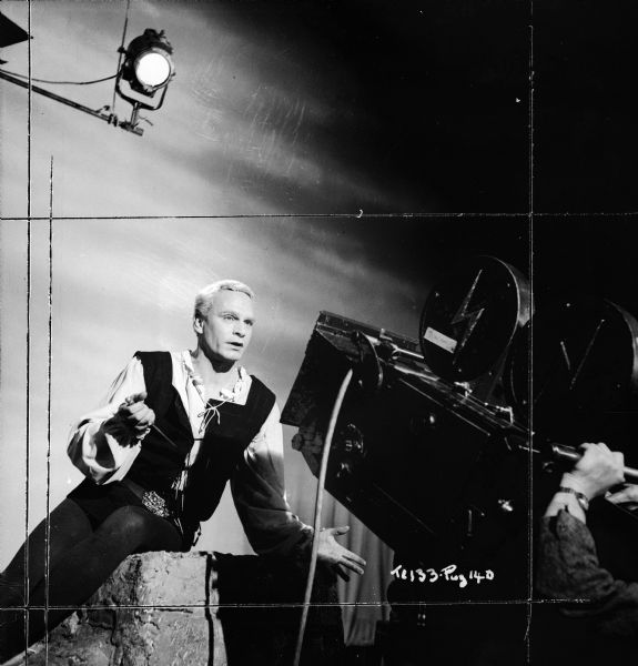 Actor and director Laurence Olivier filmed while performing the "To be or not to be" soliloquy from the 1949 film "Hamlet." A light is in the upper left corner, and a movie camera is in the right foreground. 