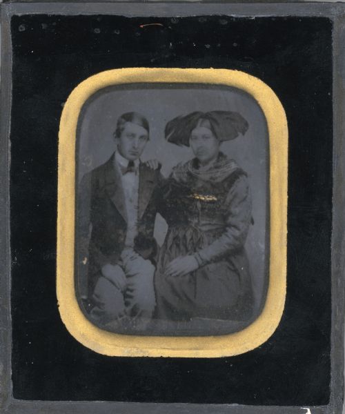 A seated, three-quarter length portrait of a clean shaven young man, and a young woman with a large fabric headpiece. Gold decoration has been applied to the image over the woman's bodice. A notation on the reverse states: "George Brumder and sister Anna Marie just prior to migration to America in May 1857." Natives of Breuschwickersheim, Alsace, the pair traveled together to Milwaukee, where Anna Marie was married to Gottlieb Reim, a Lutheran pastor, on August 17, 1857.