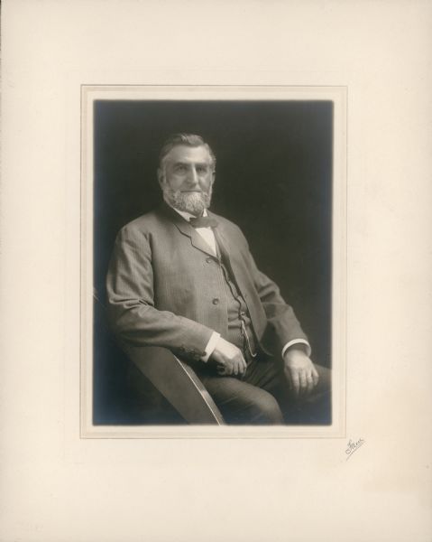 A seated, three-quarter length portrait of George Brumder (1839-1910). He is wearing a three-piece suit and bow tie, watch fob, and wedding ring. He has a well trimmed beard but no mustache. Born in Breuschwickersheim, Alsace (now France), Brumder settled in Milwaukee in 1857 and established a successful German language publishing company. He also had business interests in banking and insurance; his descendants include many prominent citizens of Milwaukee.  