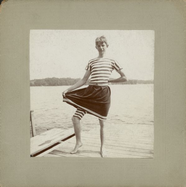 Herman Otto Brumder (1880-1950) modeling a skirted men's swimsuit on a pier at Pine Lake.  