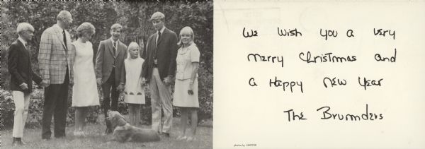 The inside group portrait and handprinted greeting of a French fold Christmas card from "The Brumders." The well-dressed family is standing and holding hands, with a dog in the foreground. They are, from left: David Hopkins Brumder; Robert Charles Brumder and wife Barbara (Blakney); Charles Pierce Brumder; Amy Ann Brumder; Robert Blakney Brumder; and Thekla Belinda Brumder.  