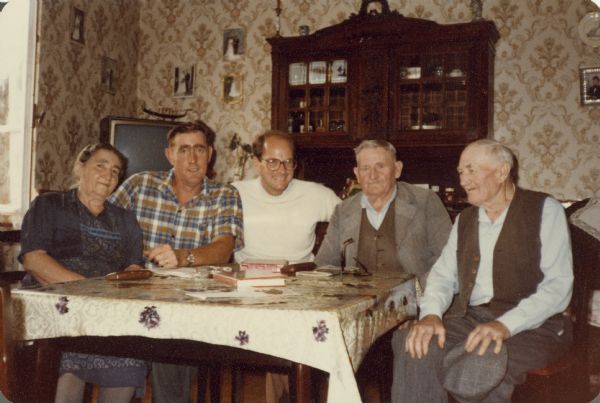 Frederick Brumder (1943-2012), in white sweater, is sitting at a table with relatives in Breuschwickersheim, Alsace, France. The other people are, from left: Barbe (Frau Charles) Kiefer, age 76; her son, Ernest Kiefer, 41; Brumder; Charles Kiefer, 78; and Phillipp Kiefer, 83. Frederick Brumder and Ernest Kiefer are third cousins. Brothers Charles and Phillipp Kiefer are grandsons of Catherina Brumder Kiefer, a sister of Milwaukee publisher and businessman George Brumder (1839-1910).