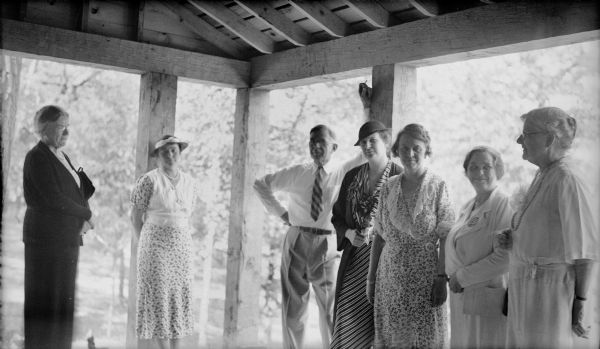 Herman Otto Brumder, third from left, leaning against a large column of a newly built addition at the Pine Lake summer home of his younger brother, Herbert Paul Brumder. Six women are with him and include his wife, Myrtle Edwards Brumder, second from right. Margaret Bouer (Mrs. Herbert P.) Brumder is third from right. The other women are not identified.