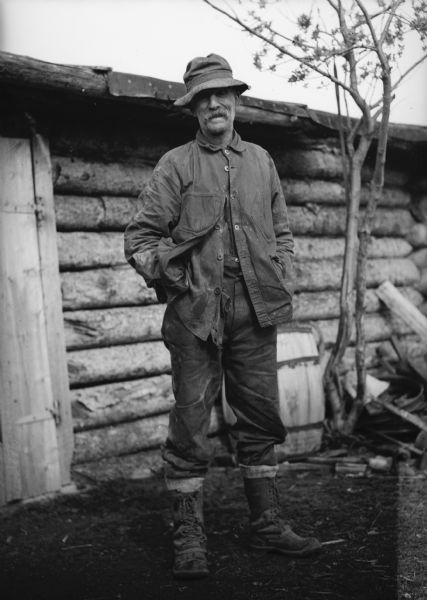 One of a group of images under the headline: "Matanuska Valley Colonists Wait for Mail, Carry Water, Haul Logs." Original caption reads: "J.J. Bugge, Minnesota Scandinavian, was the first farmer in the valley. He has been there 20 years and praises the fertility of the soil. He went there looking for gold, found it, and lost his 'poke' trying to get more."