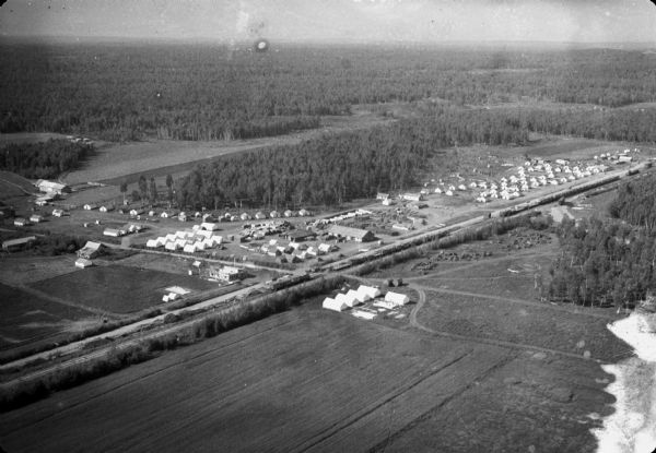 Aerial view of. Original caption on AP print reads: "Matanuska Valley, Alaska, Sept. 15--Twentieth Century Pioneers--Breaking a wilderness to the purposes of man, colonists from mid-western states are gaining a new start in life through the federal government's Matanuska valley project. This striking air picture shows Palmer Headquarters Camp and surrounding territory."