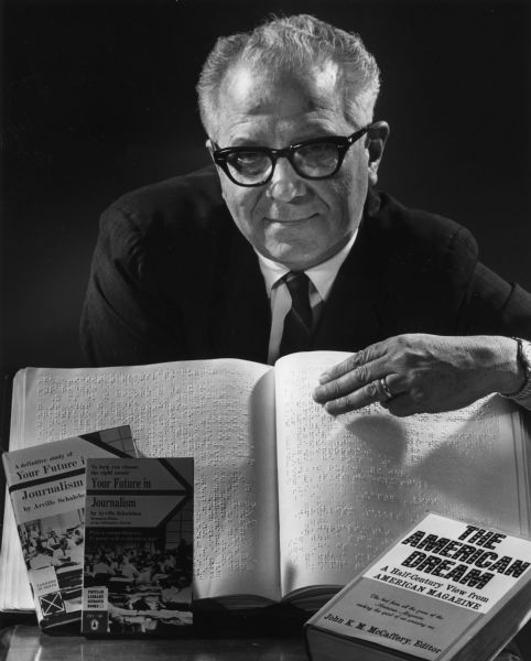 Portrait of Arville Schaleben with his book. "Your Future in Journalism," in hard cover, paper back and in braille.