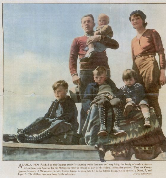Caption reads: "Alaska, Ho! Perched on their luggage ready for anything which their new deal may bring, this family of modern pioneers set out from near Superior for the Matanuska valley in Alaska as part of the federal colonization project. They are George Conners, formerly of Milwaukee; his wife, Edith; Junior, 2, being held by his father; Irving, 9 (on suitcase); Dixon, 7, and Joyce. 3. The children have new boots for the adventure. — Journal Color Photo."