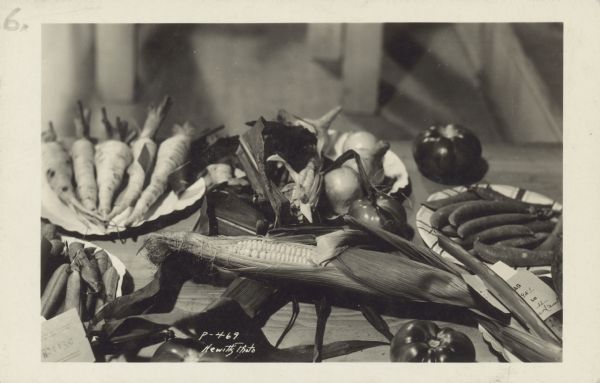Caption handwritten on back reads: "vegetable display at colony's first fair. NOT my picture, obviously, but Hewitt's of Anchorage, who was first rate."