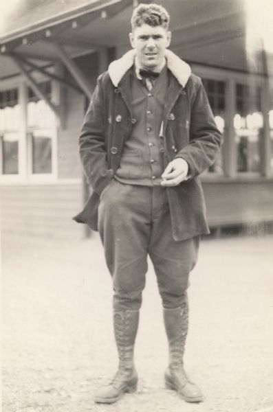 Original caption reads: "Harold Davis, who had bad experience in Alaska and became influential as a colonist among the pioneers." He is standing outdoors, and there is a building in the background.