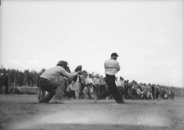 Original caption reads: "Foster, catching for the transients, and Karlovitch, batting for Anchorage, in the baseball game June 23."