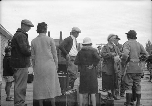 Original caption reads: "Families leaving from colony -- Shown on platform at Matanuska village, where caught train for Seward. Otto Fisher family shown in negative six. Other negatives not exposed."