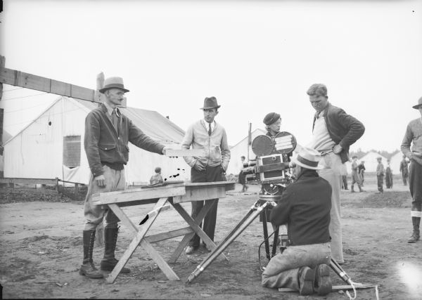 Original caption reads: "Newsreel men re-enact the colony land drawing (or lottery)."