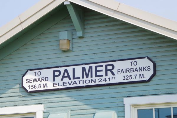 Palmer Railroad Depot Sign, that reads: "To Seward 156.8 M., Palmer Elevation 241 FT, to Fairbanks 325.7 M."