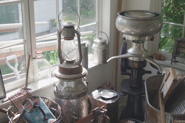 Items on display on a back porch of the Colony House Museum. One of the items on display is a McCormick-Deering Cream Separator. 
