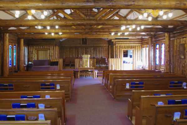Interior view of the church looking towards the altar.Constructed in 1937, the building is also known at the Church of a Thousand Trees. It is a rustic log two-story structure, in the shape of a cross. The interior is shaped from rustic log elements, with carved pews. The church was listed on the National Register of Historic Places in 1980.