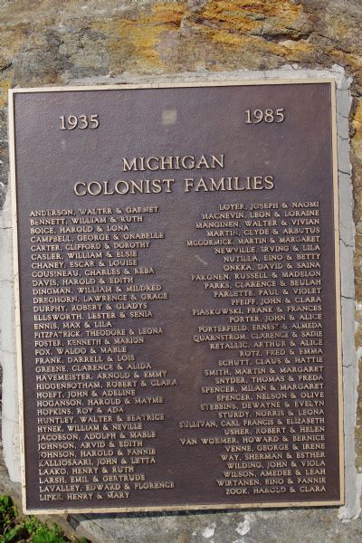 Plaque for Michigan Colonist Families, outdoors on a rock, 1935-1985.