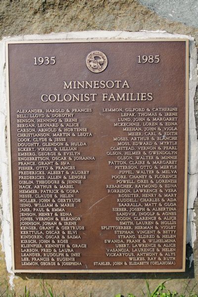 Plaque for Minnesota Colonist Families, outdoors on a rock, 1935-1985.