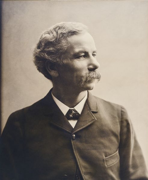 Waist-up studio portrait of H.H. Bennett.