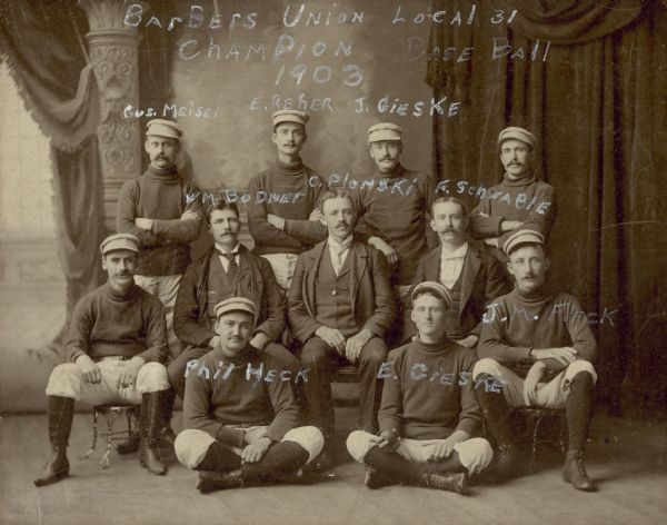 Studio group portrait of men on the Champion Base Ball team. Most of the men are identified.