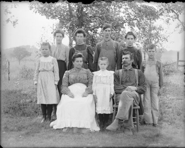 Kate and August Hernkind, sitting, are posing with their seven children outdoors. Daughter Nellie is standing between her parents. The other children are, from left, Mary, Anna, Louise, Henry, Katie and George.  