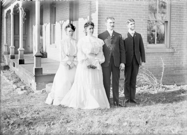 Bride Anna Kerns and groom Neil J. Brown posing with their (unidentified) attendants near the front porch of the bride's home at Hickory Hill Farm. The original owner of Hickory Hill Farm was John Muir's father, Daniel.