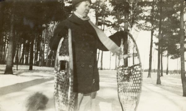 Caption reads: "Mother." The woman is standing outdoors in the snow wearing a coat, hat and scarf.