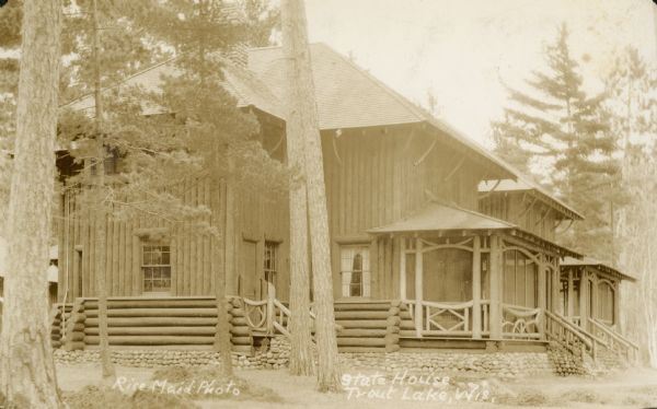 View of side of building, with the porch on the right facing Trout Lake. Caption in album reads: "Home."