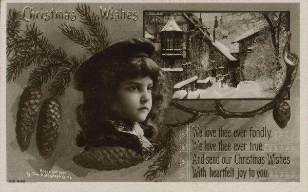 Real Photo Christmas postcard with a girl, pine branches and an inset of snow covered buildings. The girl is wearing a coat and cap. The text at top left reads: "Christmas Wishes." In the lower left it reads: "We love thee ever fondly. We love thee ever true. And send our Christmas Wishes, With heartfelt joy to you."