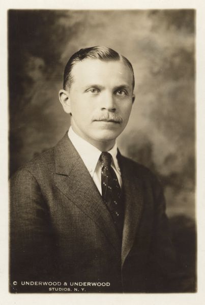 Waist-up portrait of A. J. Sack, who was director of the Russian Information Bureau and author of <i>The Birth of the Russian Democracy</i>, <i>America's Possible Share in the Economic Future of Russia</i>, and the periodical <i>Struggling Russia: A Weekly Magazine Devoted to Russian Problems</i>. Caption reads: "A. J. Sack - with Major Stanley Washburn and Russian party in Madison, Nov. 12, 1917."