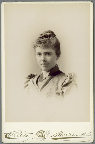 Vignetted quarter-length carte-de-visite of Hattibel [Harriet Bell] Merrill, who graduated from the University of Wisconsin-Madison with a Bachelors of Science degree in Zoology in 1890. She researched <i>Cladocera</i>, or water fleas, in Madison and in South America.