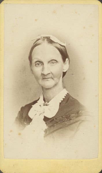 Vignetted carte-de-visite quarter-length portrait of a woman. Caption reads: "To Miss Stewart. With compliments, Of Mrs A M Abbott."