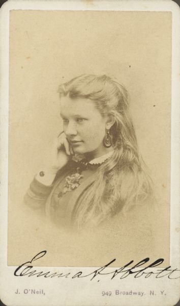 Vignetted quarter-length semi-profile carte-de-visite portrait of opera singer Emma Abbott as a youth. Caption reads: "To my darling little mother."