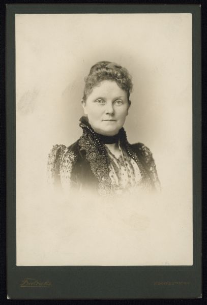 Vignetted quarter-length carte-de-visite portrait of Mary Matthews Adams, wife of Charles Kendall Adams, 1890-1902. She was a philanthropist and poet, whose published works included <i>Epithalamium</i> (N. Y. and London, 1889); <i>The Choir Visible</i> (Chicago, 1897); and <i>Sonnets and Songs</i> (N. Y. and London, 1901). This portrait was taken in Brooklyn, during the time she was married to Alfred Smith Barnes.