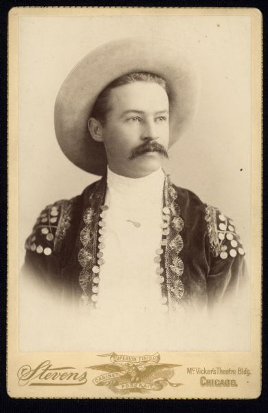 Vignetted quarter-length carte-de-visite portrait of a man wearing a hat and bolero jacket (chaquetilla). Caption identifies him as Fred Abbott of the Chicago Mandolin Orchestra.