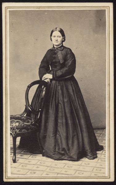 Full-length carte-de-visite portrait of Catherine Fox Adamson, daughter of Dr. William Fox and wife of Civil War captain Frederick Adamson. She was also the sister of Anna M. Fox Vilas, the wife of William Freeman Vilas.
