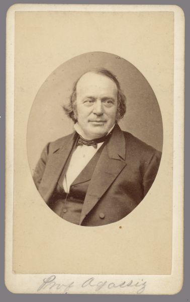 Oval-framed, waist-up carte-de-visite portrait of Jean Louis Rodolphe Agassiz, a biologist and geologist known for his studies of Earth's natural history.