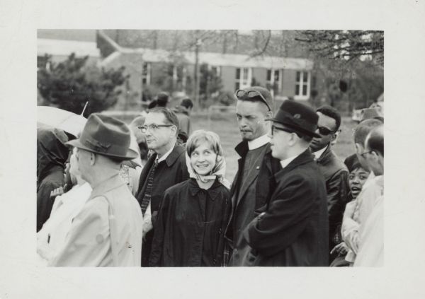 Several people are standing together, including Highlander Research and Education Center founder Myles Horton, and Presbyterian minister Rev. Joseph Metz Rollins, Jr., who is winking at the camera. Caption indicates this was "at the Selma March."